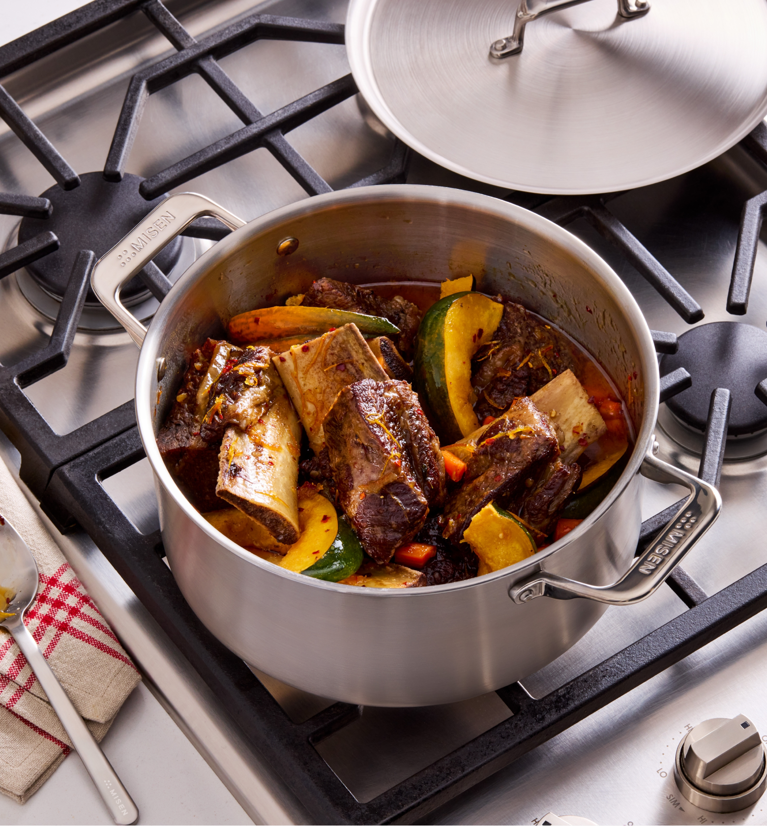 Braised beef short ribs with vegetables in Misen stainless steel pot on gas stove